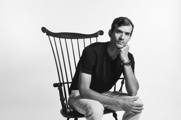 Brian Chin sitting with hand under chin