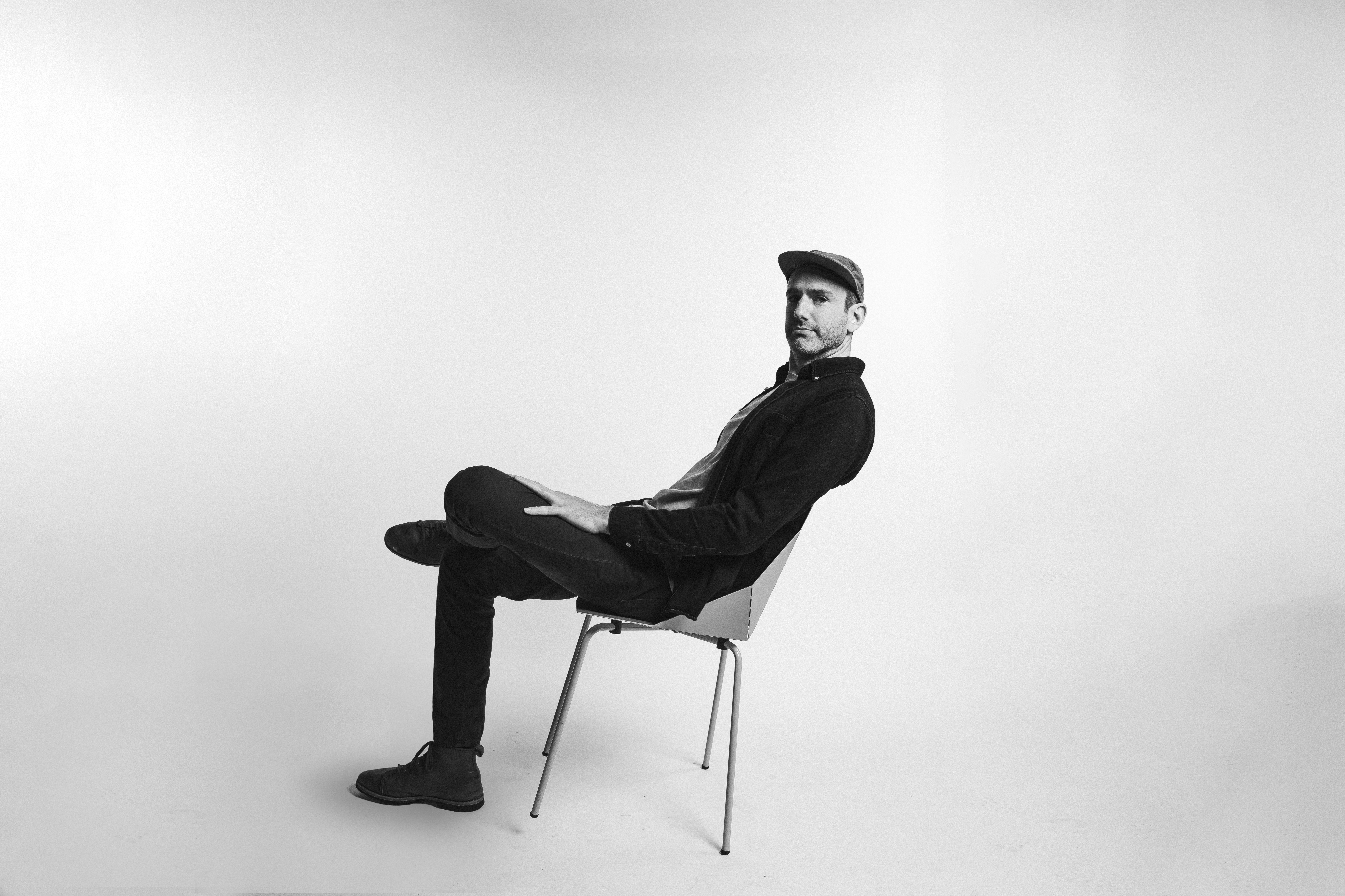B&W of Nathan Gilliss sitting down - left facing